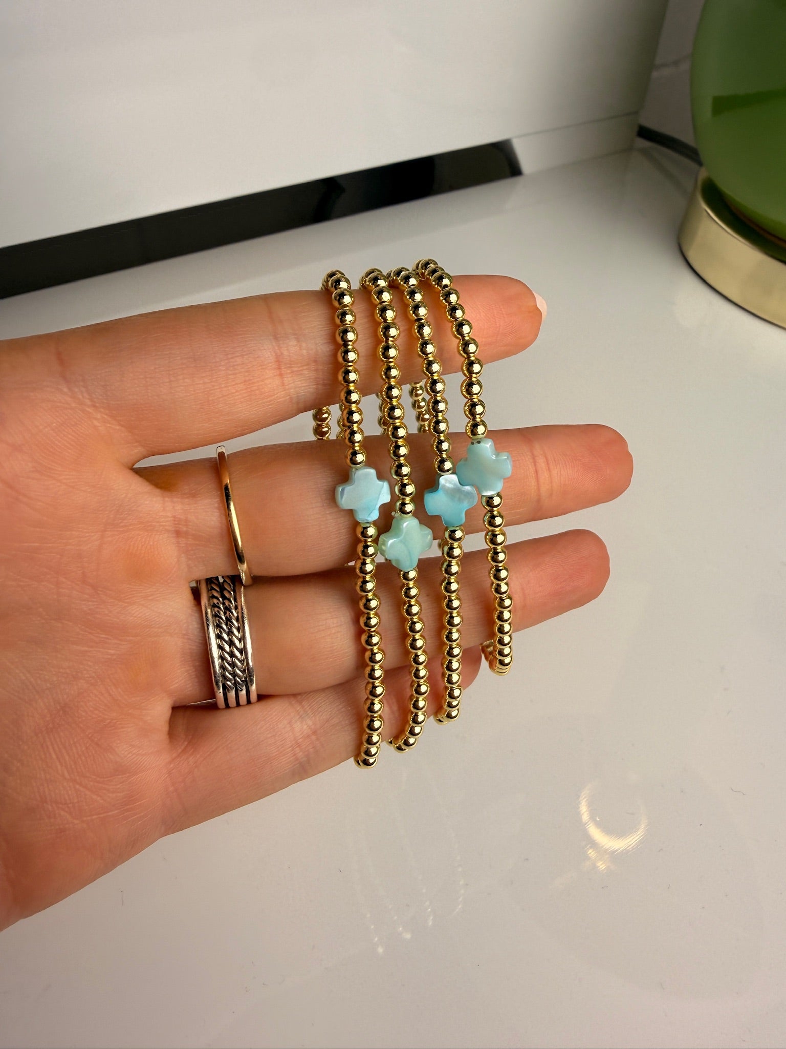 jennifer thames gold beaded bracelet with blue cross