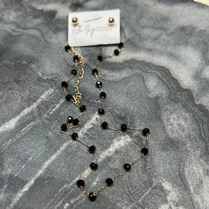string of gems necklace and earrings set in black