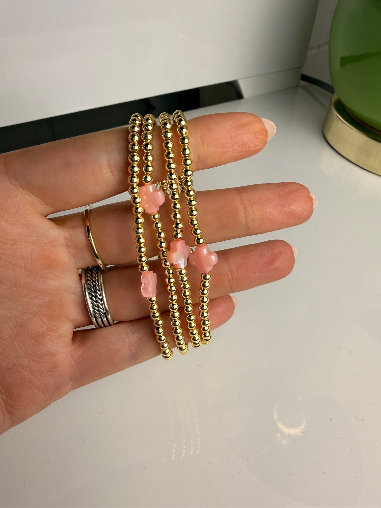 jennifer thames gold beaded bracelet with pink cross